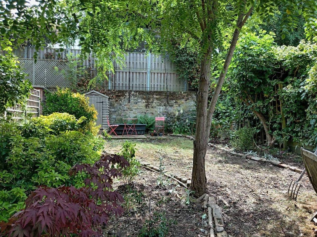 The same back garden cleared by H&O in one visit — tidy open ground, bistro seating and breathing space restored